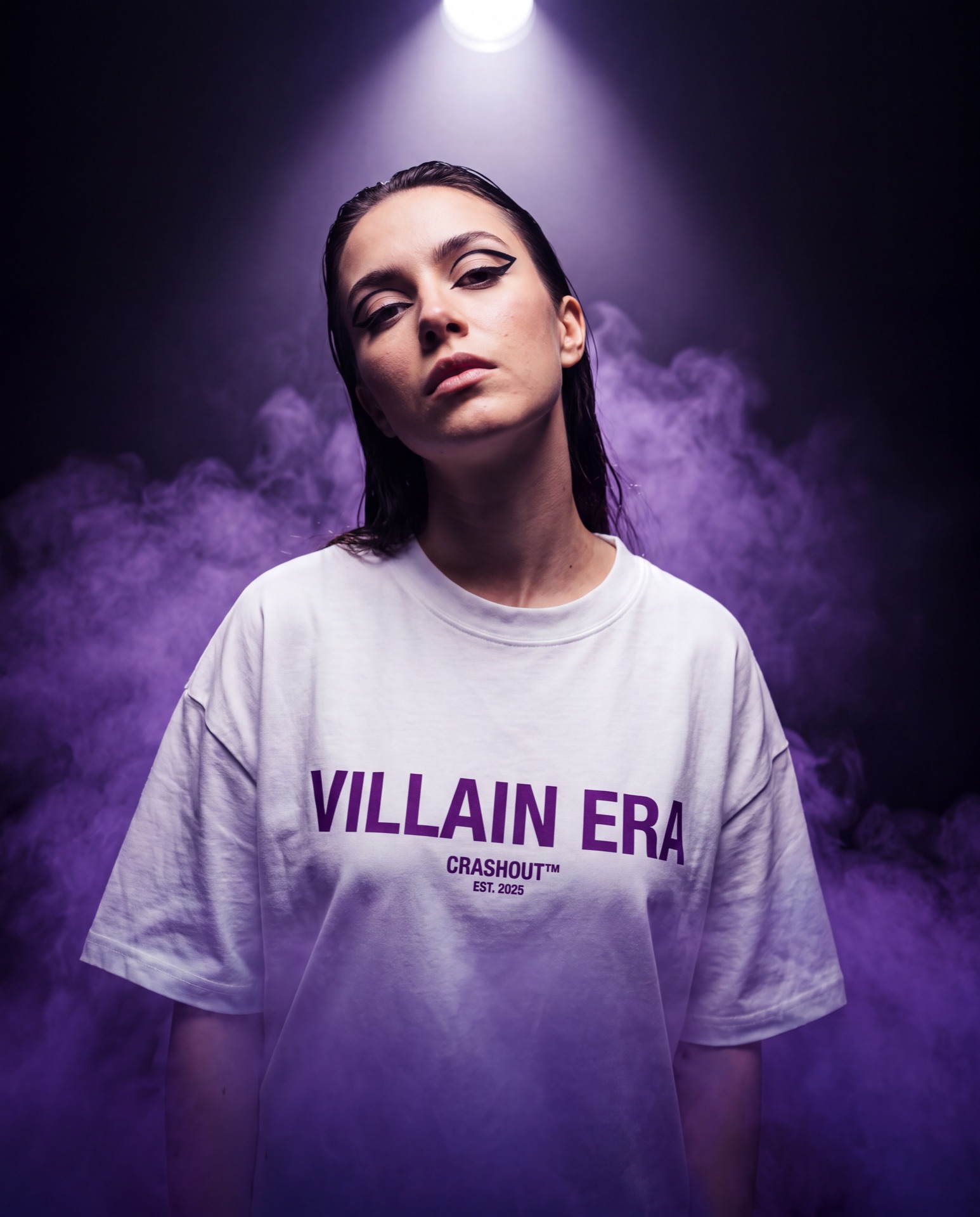Model emerging from purple smoke wearing a Villain Era tee